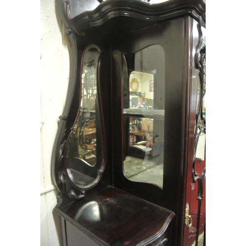 195 - Victorian mahogany display cabinet with ornate scroll decorated back, shaped bevelled mirror insets,... 