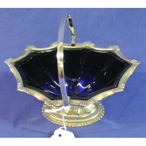 12 - Silver plated sugar basket of hexagonal tapering form, with swing handle and blue glass liner