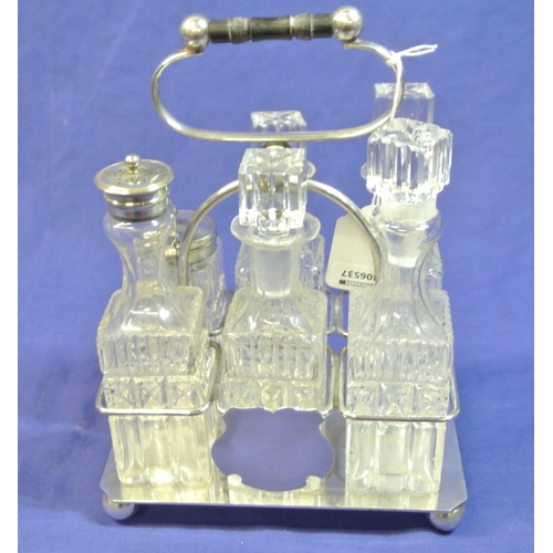 18 - Victorian style silverplated cruet set with six glass bottles and shaped handle