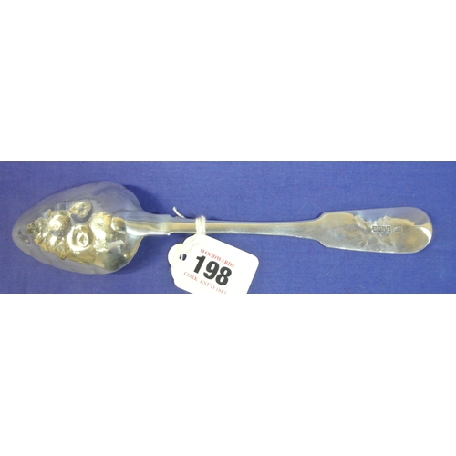 198 - Irish silver berry spoon with foliate decorated fiddle pattern handle and embossed bowl, by Laurence... 