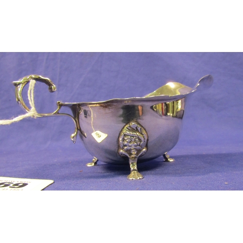 269 - Irish silver boat shaped sauceboat with wavy rim, scroll handle, on 3 cast feet, by O'Connell, Cork.... 