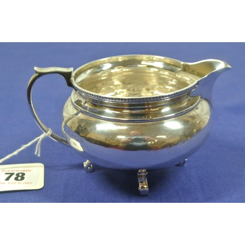 78 - Birmingham silver round creamewer with beaded rim and shaped handle, on 4 scroll feet