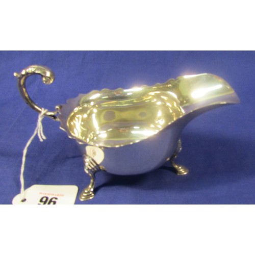 96 - Birmingham silver sauceboat with wavy rim, scroll handle, on 3 hoof feet  15cm