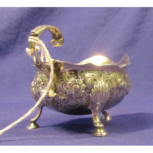 208 - Irish silver small sauceboat, ornately embossed with scrolls and foliage, with S-shaped handle and h... 