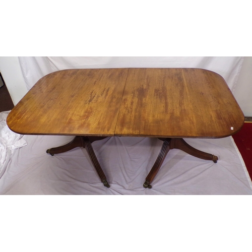 25 - Edwardian mahogany twin pillar dining table with reeded borders, raised on turned columns with reede... 