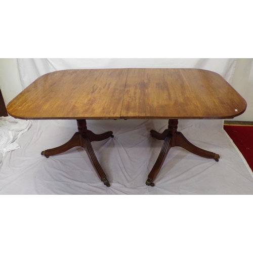 25 - Edwardian mahogany twin pillar dining table with reeded borders, raised on turned columns with reede... 