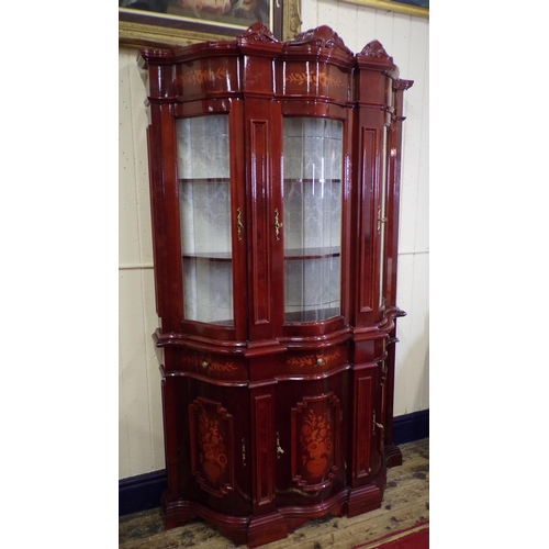 125 - French style serpentine fronted display cabinet with scroll decorated pediments, foliate inlay, shap... 