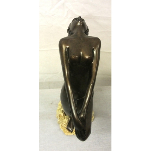 136 - Ornate bronzed ornament of a nude, on rocky base