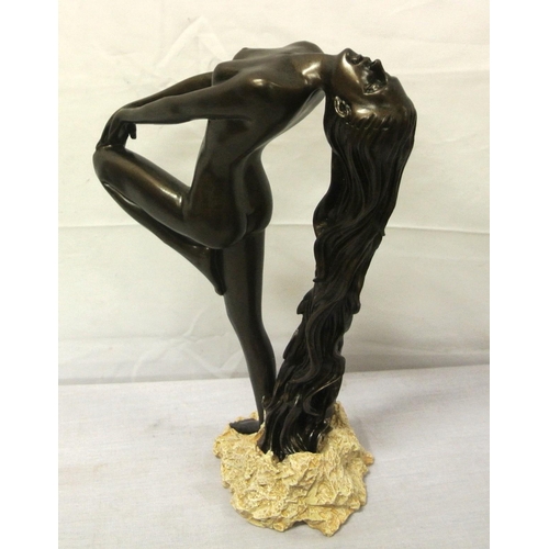 136 - Ornate bronzed ornament of a nude, on rocky base