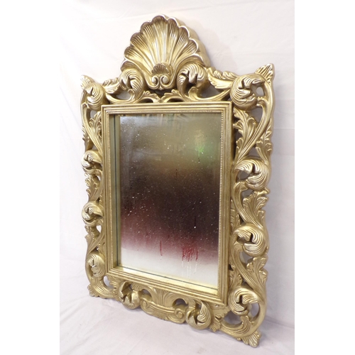 141 - Ornate gilt framed wall mirror with shell and foliate decoration