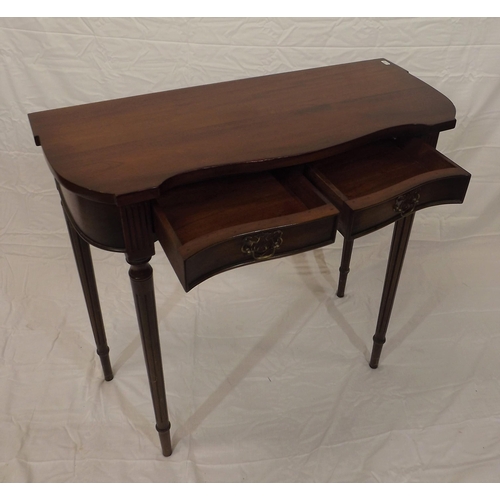 129 - Edwardian mahogany hall or side table with serpentine front, two frieze drawers with brass drop hand... 