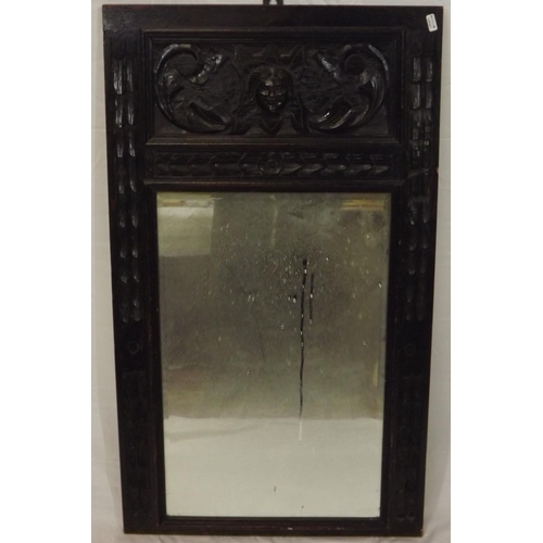 134 - Arts & Crafts carved oak framed bevelled glass wall mirror with foliate decoration