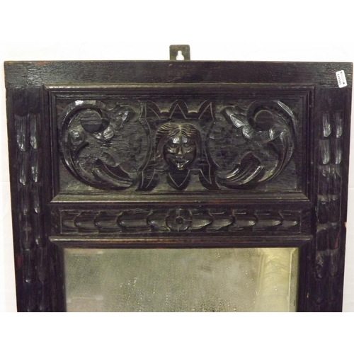 134 - Arts & Crafts carved oak framed bevelled glass wall mirror with foliate decoration