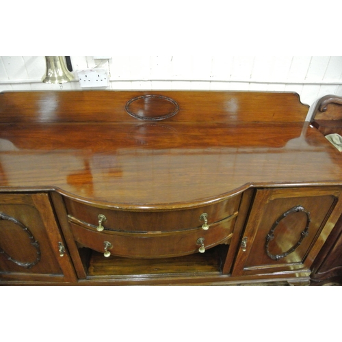 145 - Edwardian mahogany bow fronted sideboard with tray back, two central drawers, shelved side presses w... 