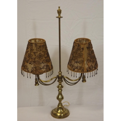147 - French style double electric lamp with shaped tassels and round base.