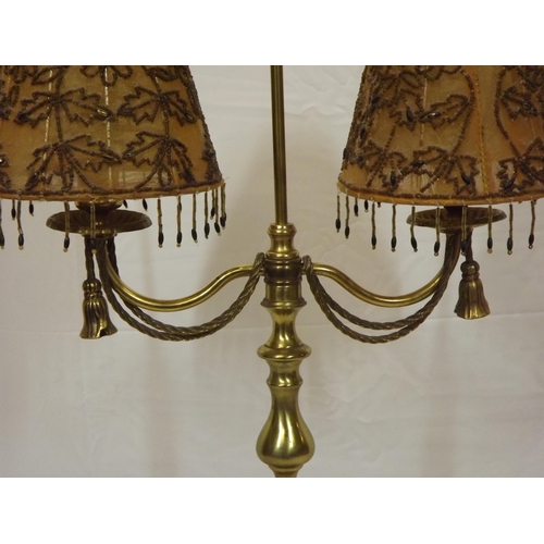 147 - French style double electric lamp with shaped tassels and round base.