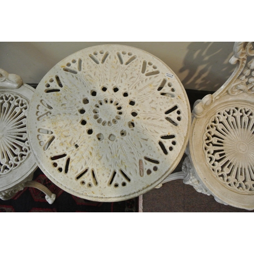 157 - Three piece cast iron garden or patio set, round table and pair of chairs with ornate scroll decorat... 