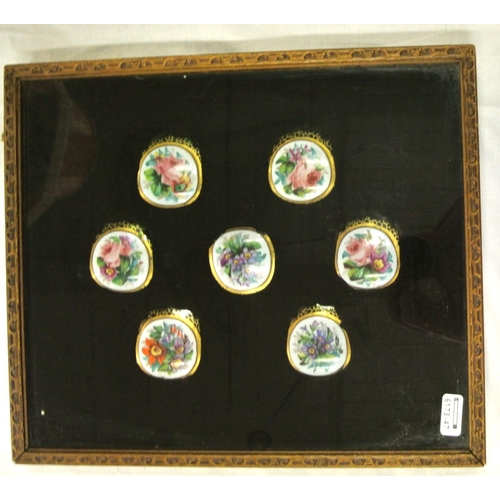 168 - Set of seven foliate decorated enamel and green glass jar tops in presentation case