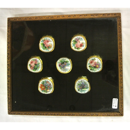 168 - Set of seven foliate decorated enamel and green glass jar tops in presentation case