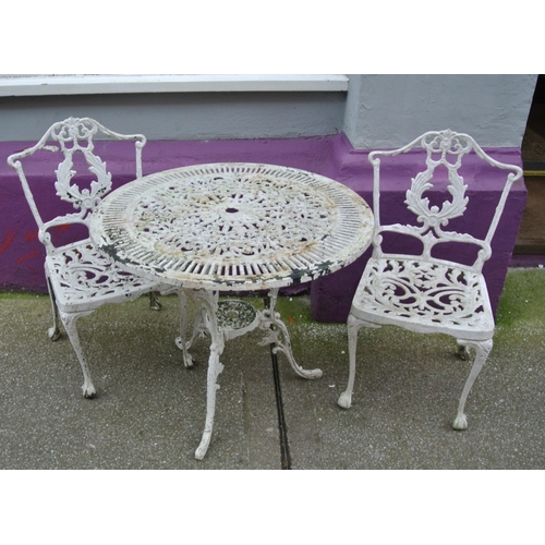 183 - Three piece wrought iron garden or patio suite with foliate decoration, table and two  shaped backed... 