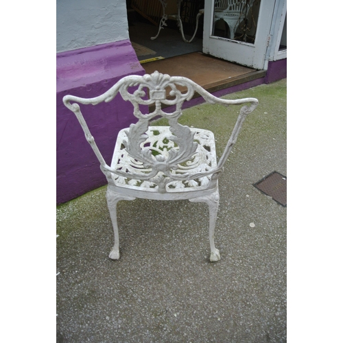 183 - Three piece wrought iron garden or patio suite with foliate decoration, table and two  shaped backed... 