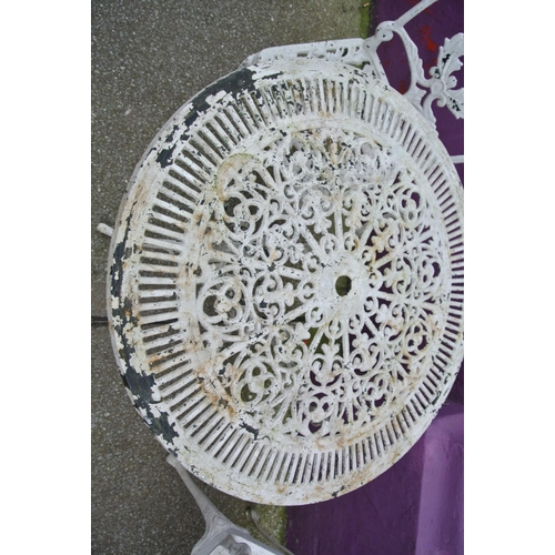 183 - Three piece wrought iron garden or patio suite with foliate decoration, table and two  shaped backed... 