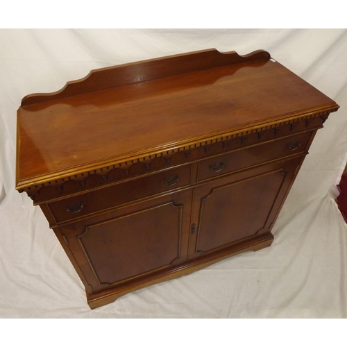 20 - Edwardian style yew cabinet with dentil frieze, two frieze drawers with shelved press under, on brac... 