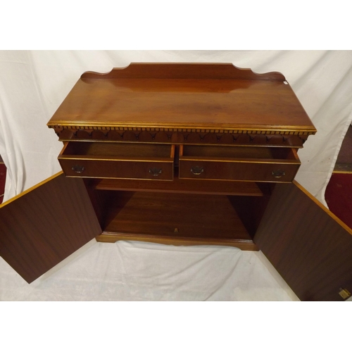 20 - Edwardian style yew cabinet with dentil frieze, two frieze drawers with shelved press under, on brac... 