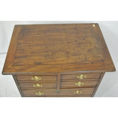 46 - Edwardian mahogany commode with lift-up lid, chest of drawer front with drop handles, on bracket fee... 