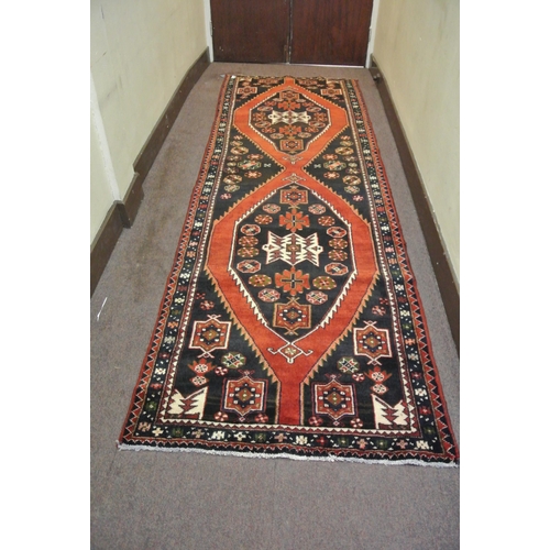 58 - Terracotta ground Persian hamadan runner with aztec medallion design 329x113
