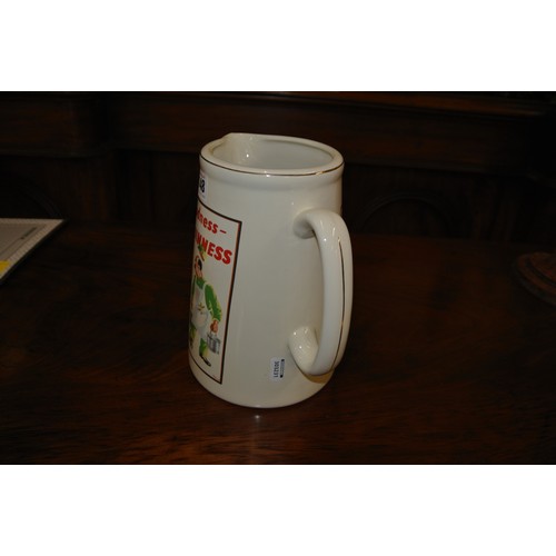 19 - Guinness advertising ewer with figured decoration and shaped handle