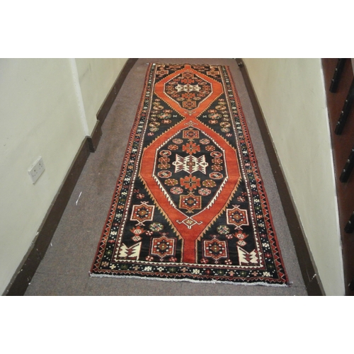 68 - Terracotta ground Persian hamadan runner with aztec medallion design 329x113