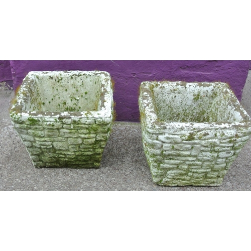 128 - Pair of old stone square garden vases with wicker edges
