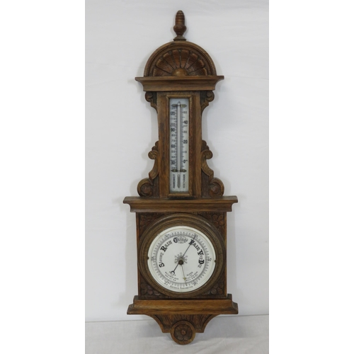 134 - Edwardian oak cased aneroid barometer with thermometer, scroll carving