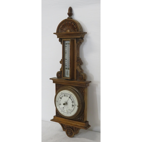 134 - Edwardian oak cased aneroid barometer with thermometer, scroll carving