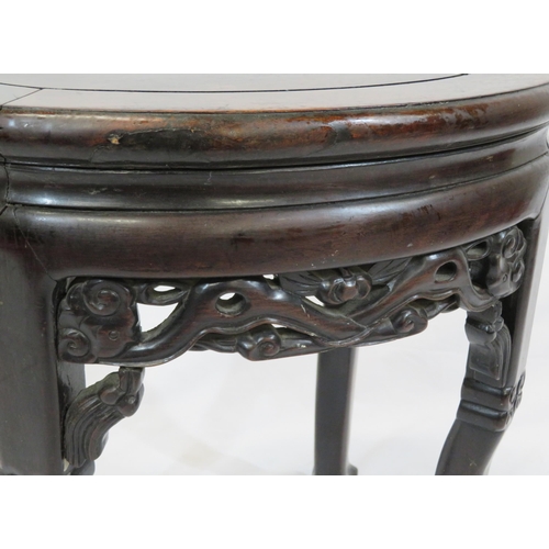 24 - Oriental oval teak stool with foliate and scroll carving