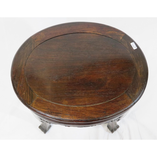 24 - Oriental oval teak stool with foliate and scroll carving