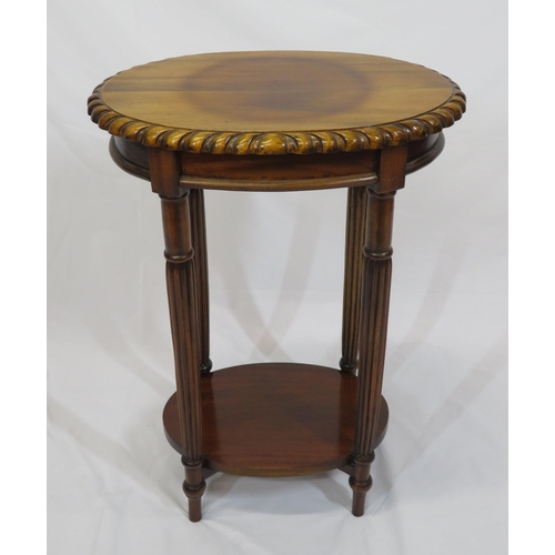 26 - Victorian style oval two tier occasional table with carved borders, and turned columns