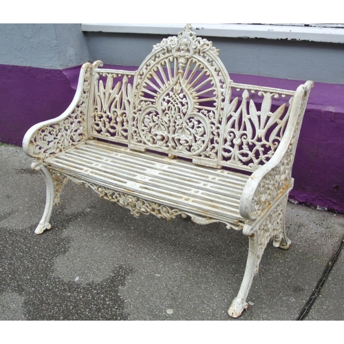 285 - Victorian style cast iron garden seat with domed back, foliate and scroll decoration, shaped legs, s... 