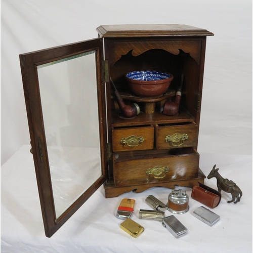 34 - Edwardian oak cased smokers cabinet with glazed door, interior fitted with drawers and pipe holders