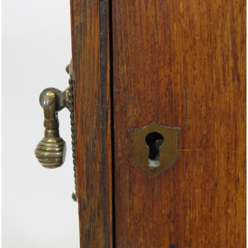 34 - Edwardian oak cased smokers cabinet with glazed door, interior fitted with drawers and pipe holders