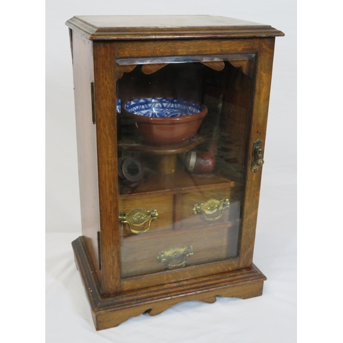 34 - Edwardian oak cased smokers cabinet with glazed door, interior fitted with drawers and pipe holders