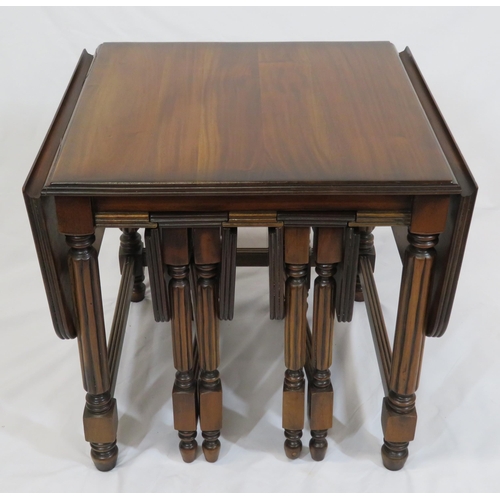 61 - Edwardian nest of three drop leaf tables with reeded borders, reeded turned columns, on round legs