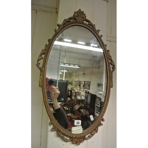 33 - Oval gilt framed wall mirror with foliate decoration