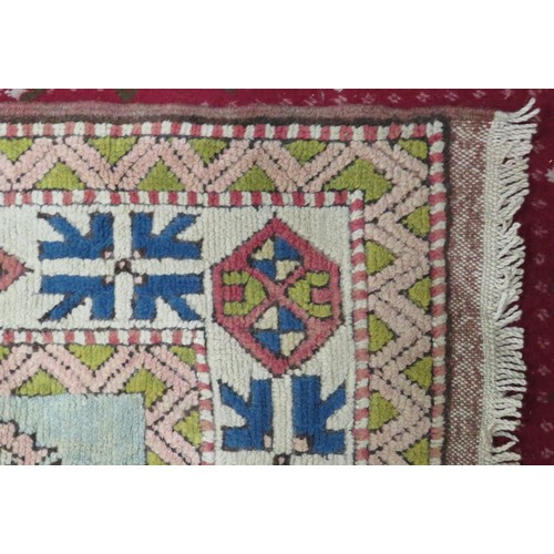 196 - Iranian style red ground hearth rug with diamond pattern. 200 x140 cm