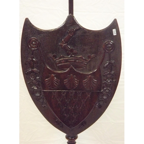 49 - Victorian mahogany pole screen having coat of arms and floral decorated shield shaped shade, turned ... 