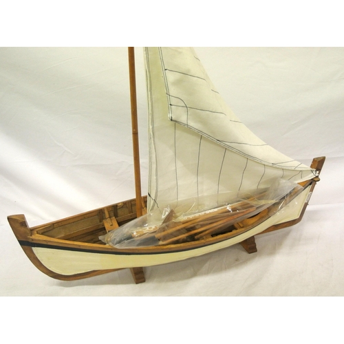 157 - Handmade timber model of a sailing skiff on stand Length 62cm by 17cm mast 57cm