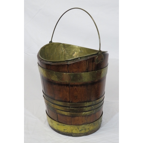 162 - Georgian walnut oval peat bucket of tapering form with brass banding and bucket inset