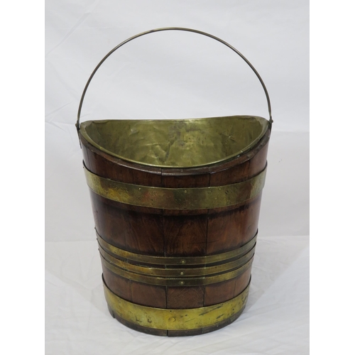 162 - Georgian walnut oval peat bucket of tapering form with brass banding and bucket inset