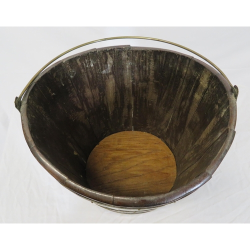 162 - Georgian walnut oval peat bucket of tapering form with brass banding and bucket inset